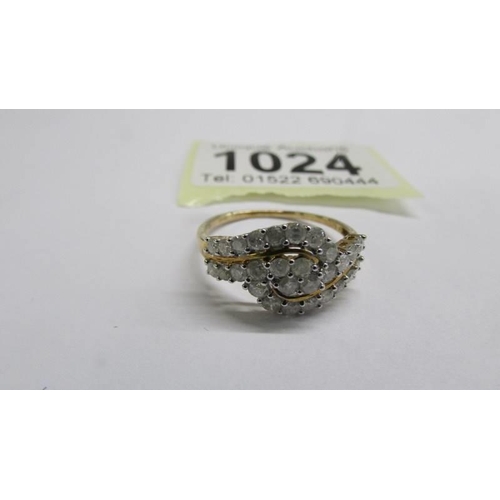 1024 - A yellow gold multi diamond swirl ring, size R half. 2 grams.