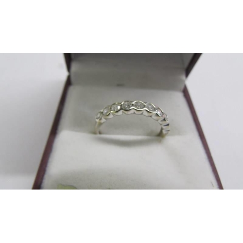 1027 - An 18ct ten stone bar diamond ring, size M, 1.65 grams.