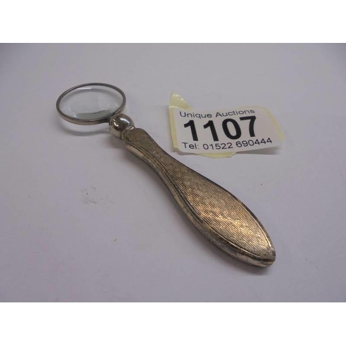 1107 - A silver handled magnifying glass.