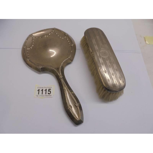 1115 - A silver hand mirror and a silver hair brush.