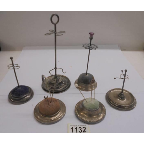 1132 - Four silver hat pin stands and two others.