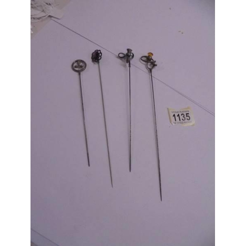 1135 - Four unmarked early 20th century hat pins.