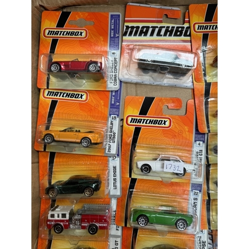 13 - A box of Matchbox cars in blister packs