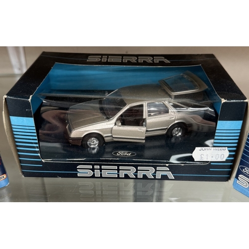 57 - 9 Ford Sierra models and Metro models by Matchbox and Corgi in blister packs and boxes