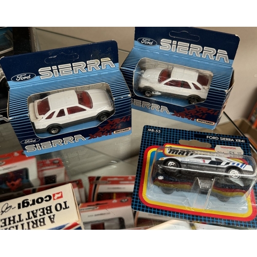 57 - 9 Ford Sierra models and Metro models by Matchbox and Corgi in blister packs and boxes