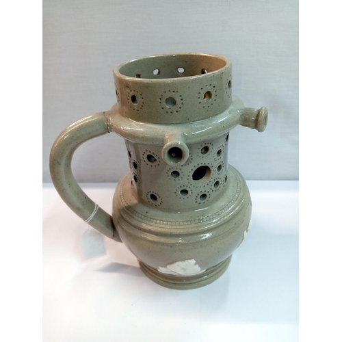 1253 - A 19th century stoneware jasperware puzzle jug, Height 20cm (handle repaired)