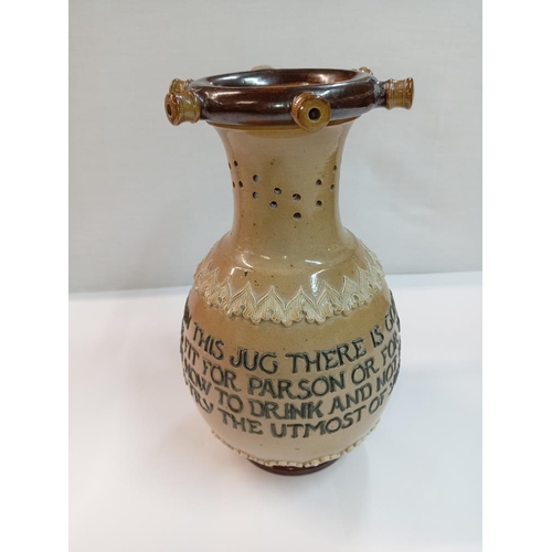 1256 - A Doulton Lambeth stoneware puzzle jug. Height 23cm