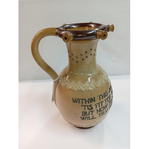 1256 - A Doulton Lambeth stoneware puzzle jug. Height 23cm