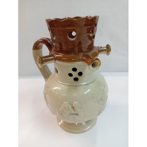 1258 - A stoneware pottery puzzle jug. Height 19cm. A/F