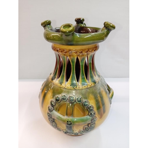 1261 - A signed slip glaze puzzle jug. Height 22cm