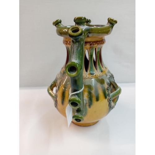 1261 - A signed slip glaze puzzle jug. Height 22cm