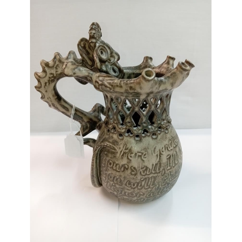 1263 - A Studio pottery puzzle jug with dragon handle. Height 22cm