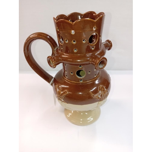 1265 - A stoneware pottery puzzle jug. Height 19cm. A/F