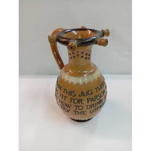 1267 - A Doulton Lambeth stoneware puzzle jug. Height 17cm. A/F