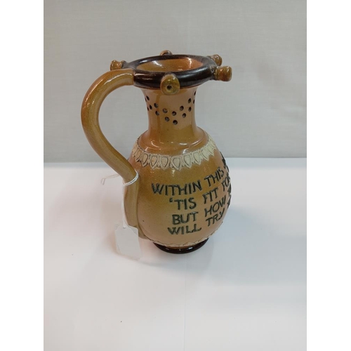 1267 - A Doulton Lambeth stoneware puzzle jug. Height 17cm. A/F