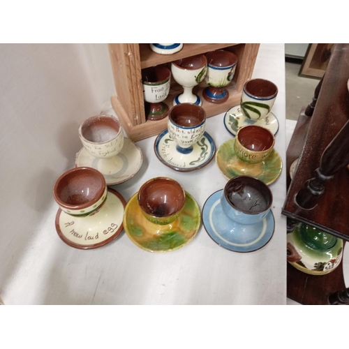 1279 - 17 egg cups on pine display stand