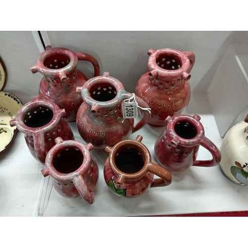 1309 - 7 pink glazed Barum Barnstaple pottery puzzle jugs