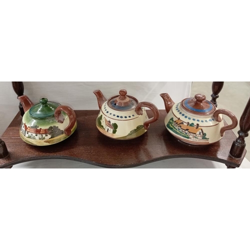 1313 - 9 Torquay ware teapots including Penzance