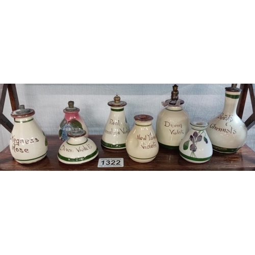 1322 - 2 shelves of Devon pottery oil/perfume bottles