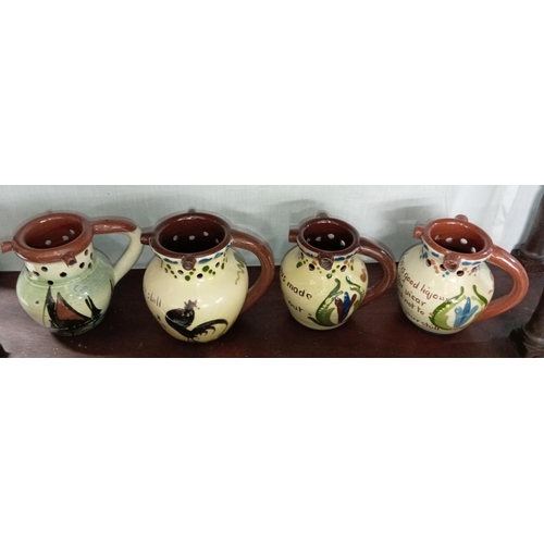 1329 - 8 Torquay ware mid size puzzle jugs