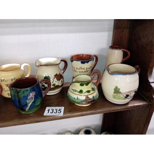 1335 - 13 Torquay ware small jugs