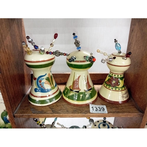 1339 - 6 Torquay ware hat pin stands