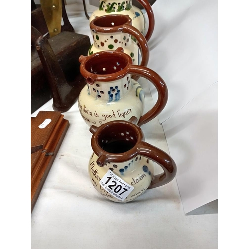 1207 - 4 Graduated Torquay pottery puzzle jugs