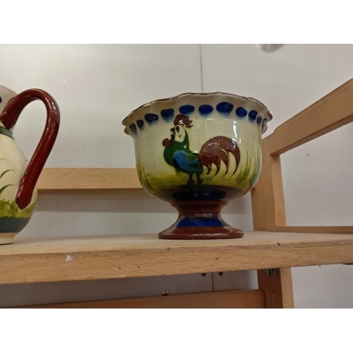 1214 - A good selection of chicken decorated pottery, 2 shelves