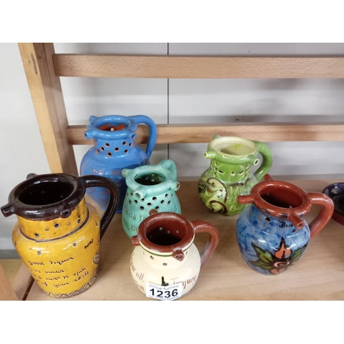 1236 - 6 Puzzle jugs including Torquay ware