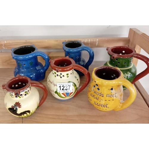 1237 - 6 Puzzle jugs including Torquay ware