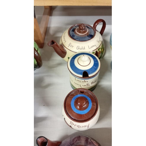 1241 - A quantity of Torquay ware preserve pots & tea pots. 7 Pieces.