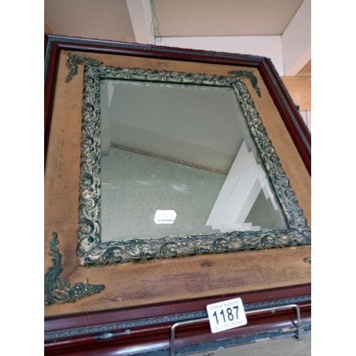 1187 - A Bevel edged mirror in a wood and metal frame.