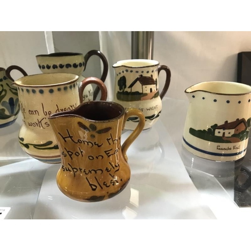 1415 - A collection of 10 Torquay ware & Motto ware jugs