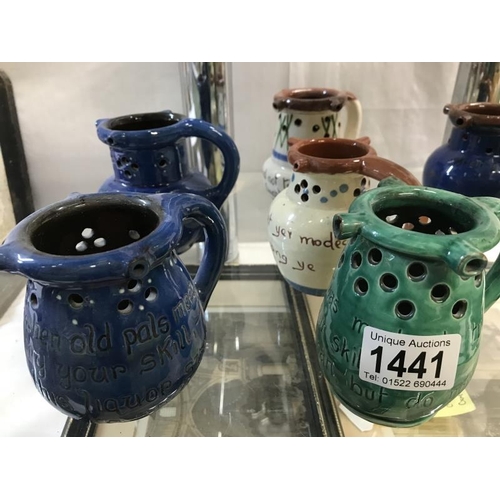 1441 - A collction of 8 Motto ware and puzzle jugs