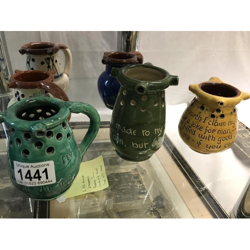 1441 - A collction of 8 Motto ware and puzzle jugs