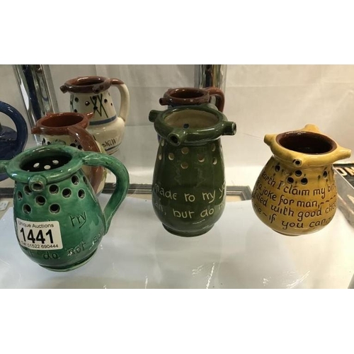 1441 - A collction of 8 Motto ware and puzzle jugs