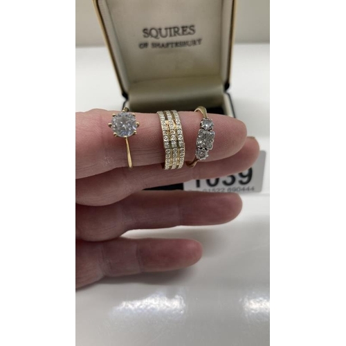 1039 - Three 9ct Gold rings. Total weight 8.04g with stones. 1x af