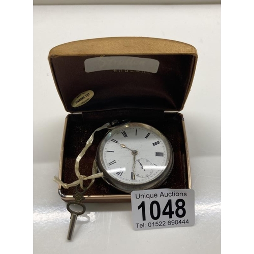 1048 - A heavy silver pocket watch with key