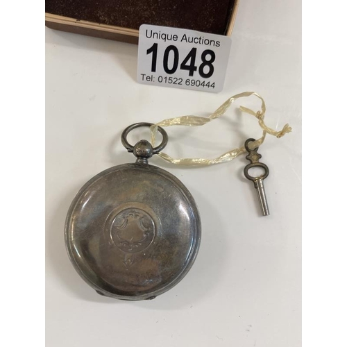 1048 - A heavy silver pocket watch with key