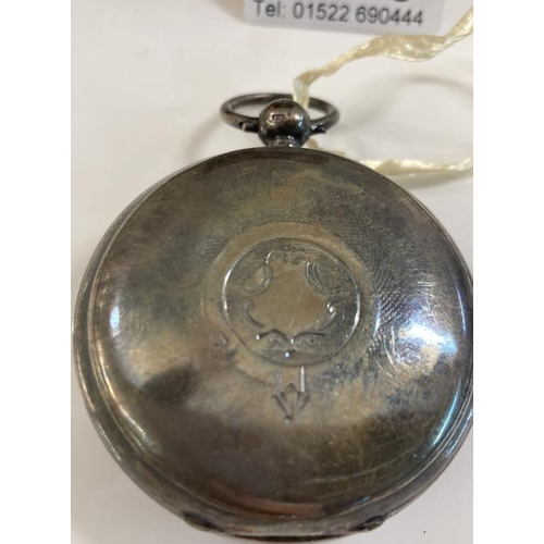 1048 - A heavy silver pocket watch with key