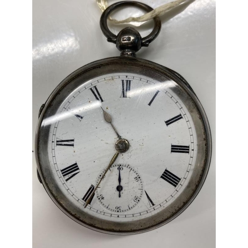 1048 - A heavy silver pocket watch with key