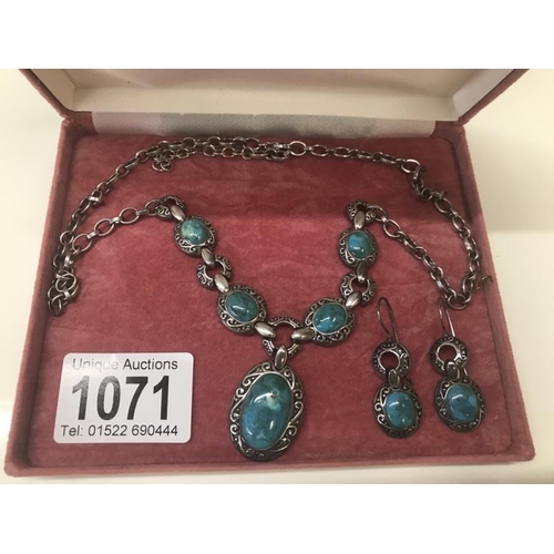 1071 - An engraved silver necklace with matching earrings set with Turquoise coloured stones