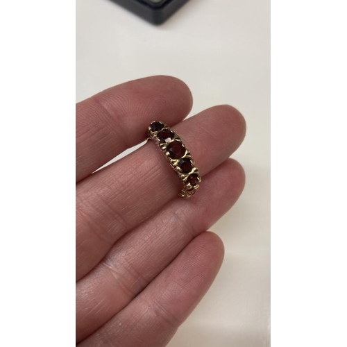 1078 - A five stone garnet set ring