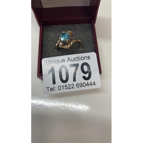 1079 - A vintage blue zircon ring set with two pearls in a rope twist setting stamped 10ct gold size L 1/4