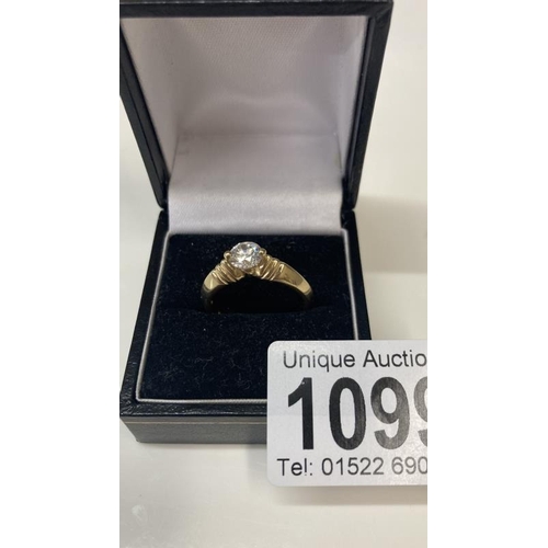 1099 - A 14ct gold ring with large solitaire imitation Diamond