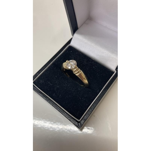 1099 - A 14ct gold ring with large solitaire imitation Diamond