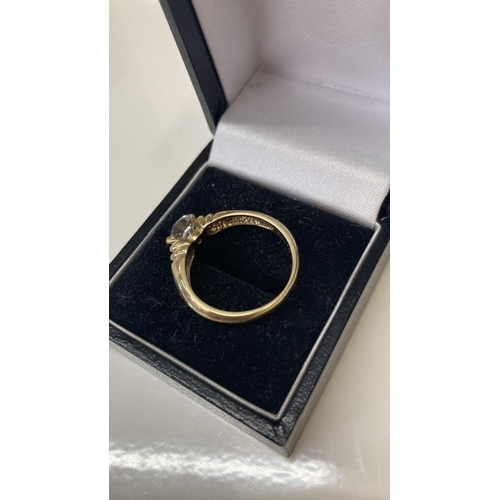 1099 - A 14ct gold ring with large solitaire imitation Diamond