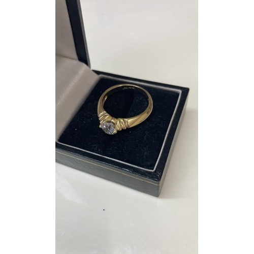 1099 - A 14ct gold ring with large solitaire imitation Diamond