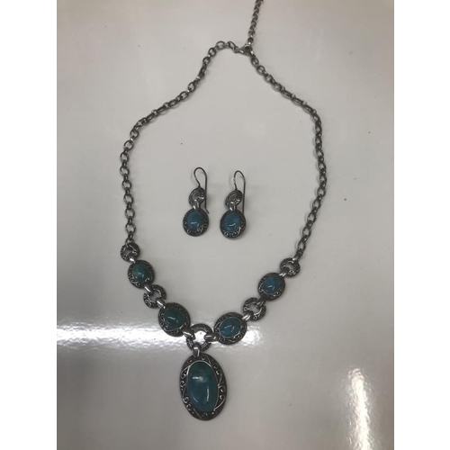 1071 - An engraved silver necklace with matching earrings set with Turquoise coloured stones