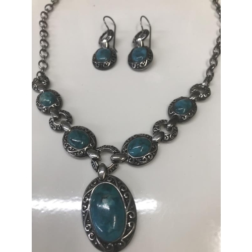 1071 - An engraved silver necklace with matching earrings set with Turquoise coloured stones